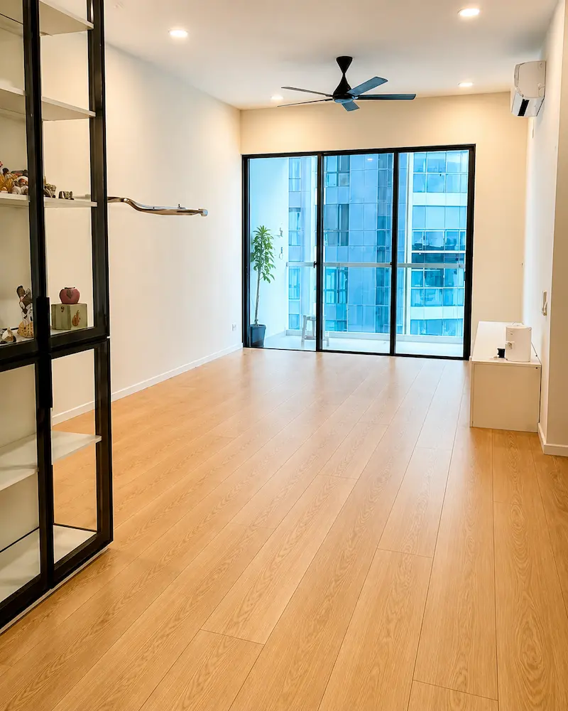 Completed laminate flooring installation in a bright living room