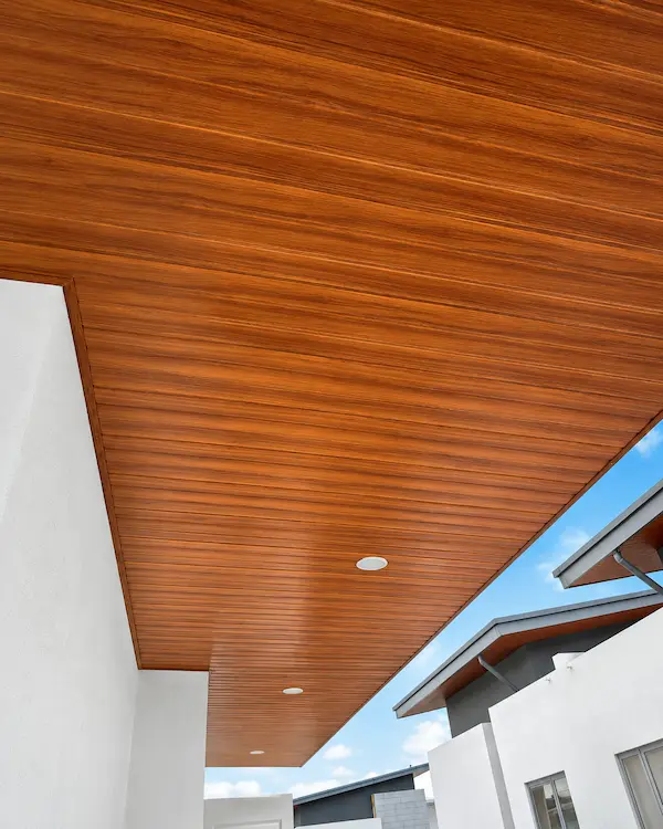 Wood-look PVC ceiling panels installed in a sheltered exterior area